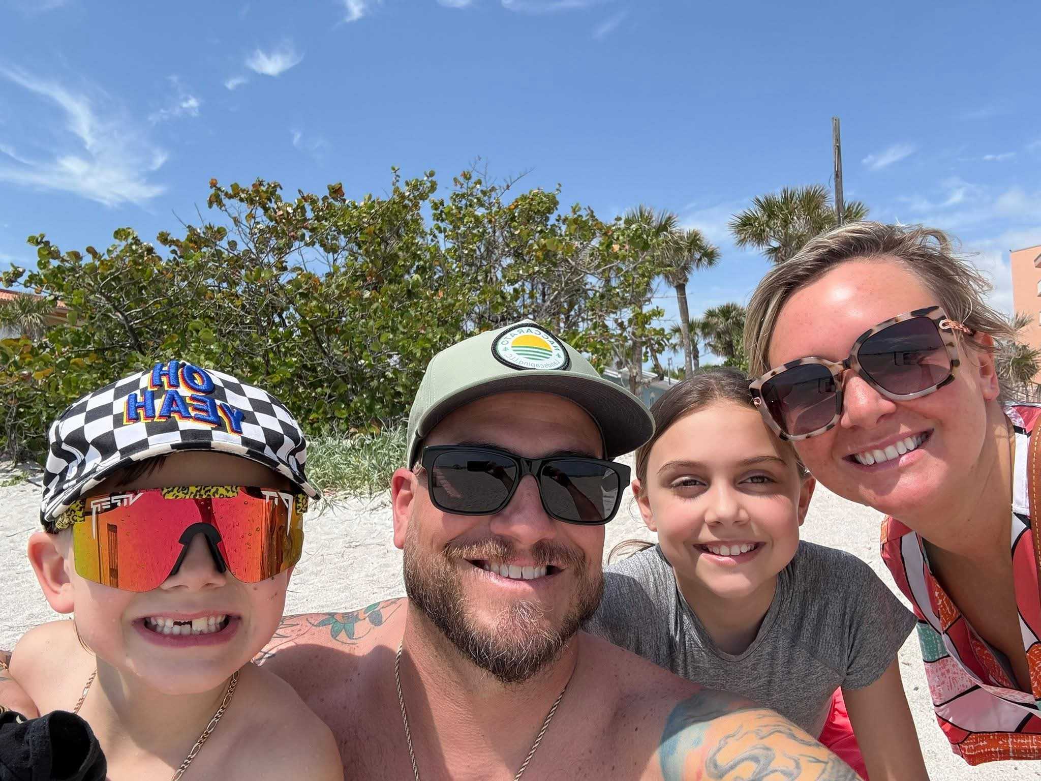 A happy family enjoys time together by the coast, showing the fun and relaxation Naccarato Landscaping Gulf Coast offers.